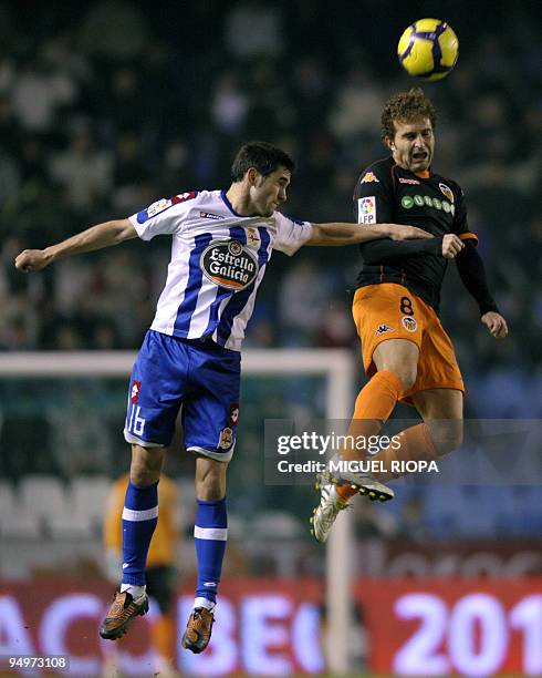 Deportivo Coruna's midfielder Antonio Tomas jumps for the ball with Valencia's midfielder Ruben Baraja during their Spanish first league football...