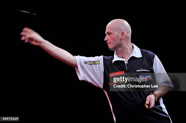 Jamie Caven of England in action against Gary Anderson of Scotland during the 2010 Ladbrokes.com World Darts Championship Round One at Alexandra...