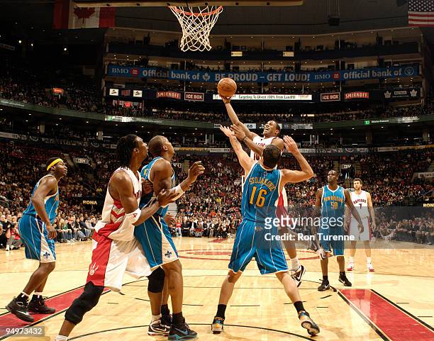 DeMar DeRozan of the Toronto Raptors streaks to the net in front of Peja Stojakovic of the New Orleans Hornets on December 20, 2009 at the Air Canada...