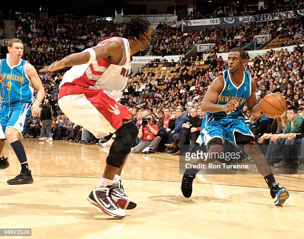 Chris Paul of the New Orleans Hornets looks to make his move against defender Chris Bosh of the Toronto Raptors during a game on December 20, 2009 at...