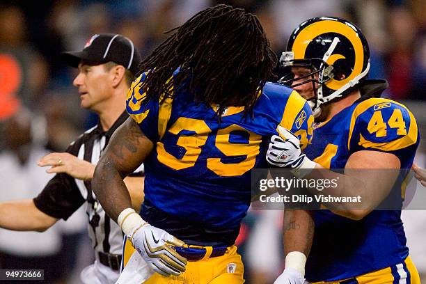 Steven Jackson of theSt. Louis Rams is restrained by teammate Mike Karney against the Houston Texans at the Edward Jones Dome on December 20, 2009 in...