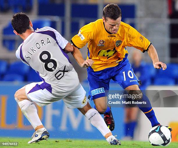 Jason Culina of United gets around Victor Sikora of the Glory during the round 20 A-League match between Gold Coast United and the Perth Glory at...