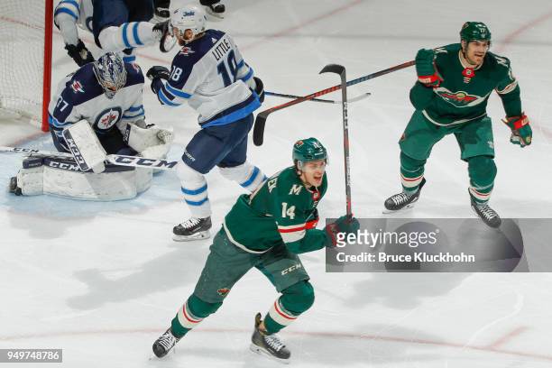 Joel Eriksson Ek celebrates his goal with teammate Marcus Foligno of the Minnesota Wild against the Winnipeg Jets in Game Three of the Western...