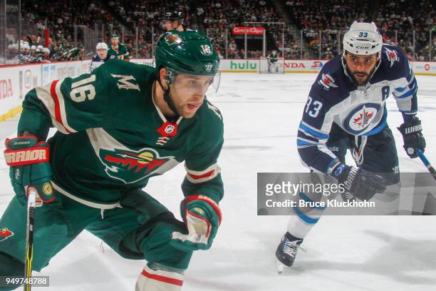 Dustin Byfuglien of the Winnipeg Jets defends Jason Zucker of the Minnesota Wild in Game Three of the Western Conference First Round during the 2018...