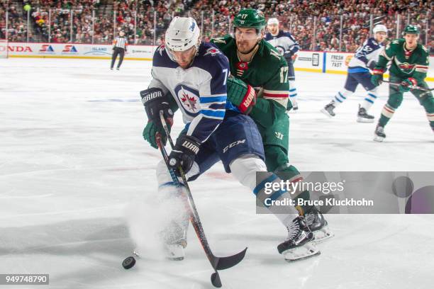 Ben Chiarot of the Winnipeg Jets and Marcus Foligno of the Minnesota Wild battle for the puck in Game Three of the Western Conference First Round...