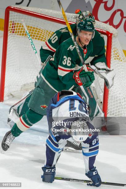 Nick Seeler and Devan Dubnyk of the Minnesota Wild defend their goal against Kyle Connor of the Winnipeg Jets in Game Three of the Western Conference...
