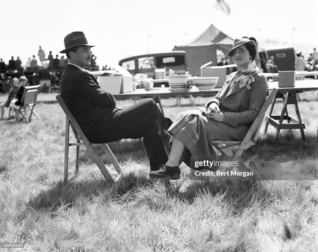 Harvey S Ladew, noted fox hunting and topiary enthusiast, and Mrs Bernard F Gimbel seated in folding chairs at the Lawridge Horse Show, Port Chester, New York, c1937