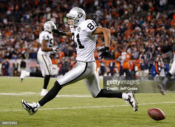 Chaz Schilens of the Oakland Raiders celebrates after scoring a touchdown late in the fourth quarter against the Denver Broncos at Invesco Field at...