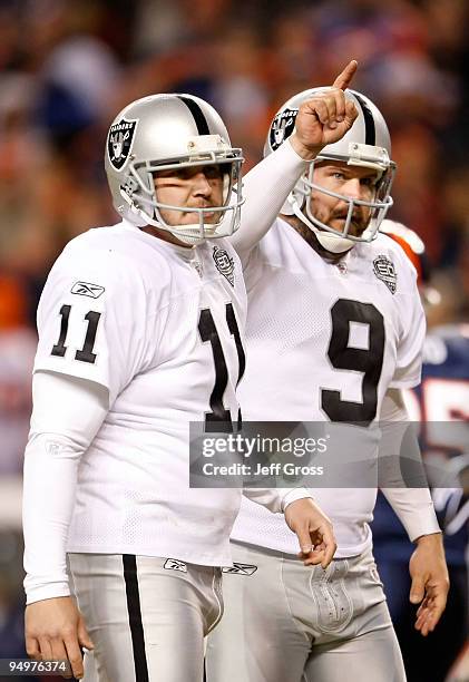 Sebastian Janikowski and Shane Lechler of the Oakland Raiders celebrate the extra point after Chaz Schilens' touchdown in the fourth quarter against...