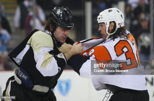 Riley Cote of the Philadelphia Flyers and Eric Godard of the Pittsburgh Penguins fight during the first period at the Mellon Arena on December 15,...