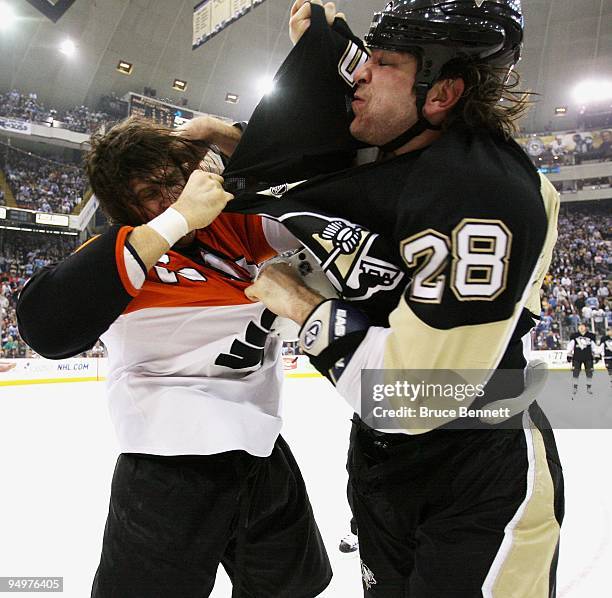 Riley Cote of the Philadelphia Flyers and Eric Godard of the Pittsburgh Penguins fight during the first period at the Mellon Arena on December 15,...
