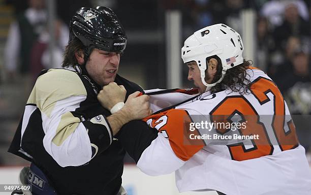 Riley Cote of the Philadelphia Flyers and Eric Godard of the Pittsburgh Penguins fight during the first period at the Mellon Arena on December 15,...