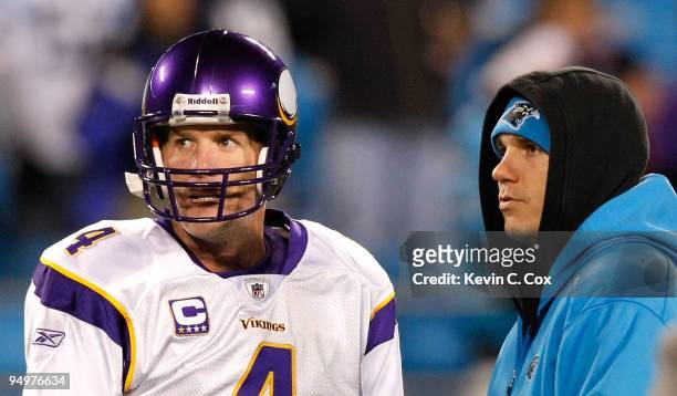 Quarterback Brett Favre of the Minnesota Vikings converses with injured quarterback Jake Delhomme of the Carolina Panthers during pregame at Bank of...