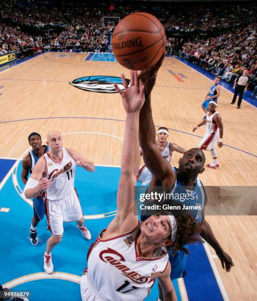 Anderson Varejao of the Cleveland Cavaliers goes up for the rebound against Tim Thomas of the Dallas Mavericks during a game at the American Airlines...