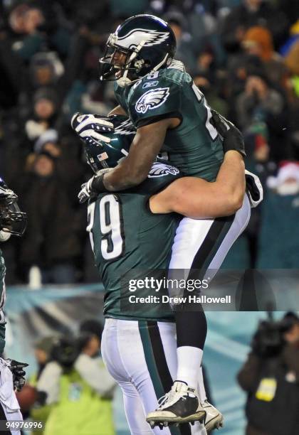 Running back LeSean McCoy of the Philadelphia Eagles jumps into the arms of teammate offensive tackle Todd Herremans after scoring a touchdown during...