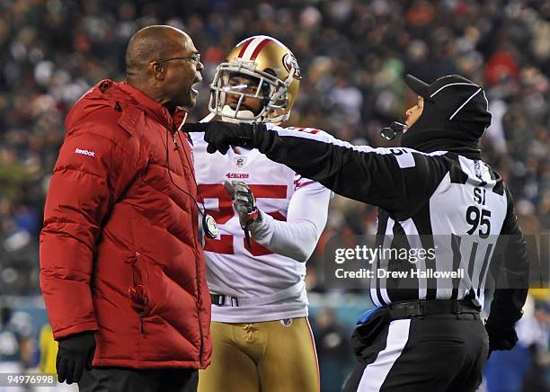 Head coach Mike Singletary of theSan Francisco 49ers yells while cornerback Tarell Brown tries to get him off the field during the game against the...