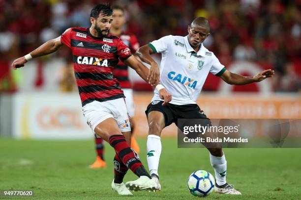 Henrique Dourado of Flamengo struggles for the ball with Juninho of America MG during a match between Flamengo and America MG as part of Brasileirao...