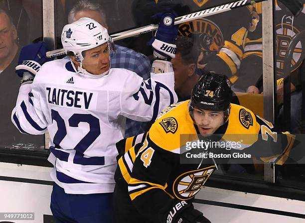 Boston Bruins Jake DeBrusk, right, collides along the boards with Toronto Maple Leafs Nikita Zaitsev, left, during the first period. The Boston...