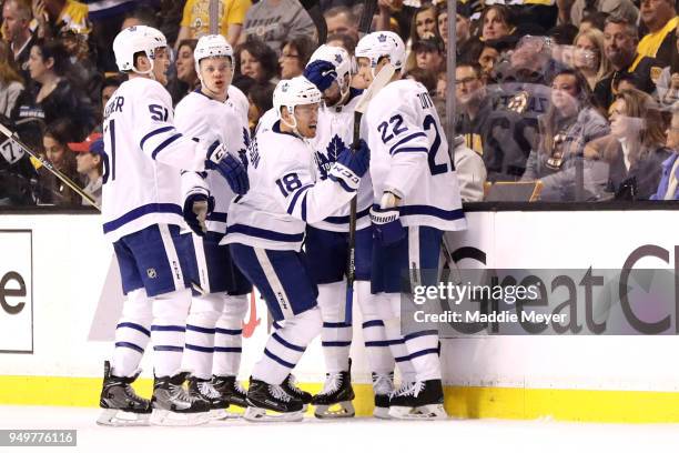 Andreas Johnsson of the Toronto Maple Leafs celebrates with Nikita Zaitsev and Jake Gardiner after scoring a goal against the Boston Bruins during...