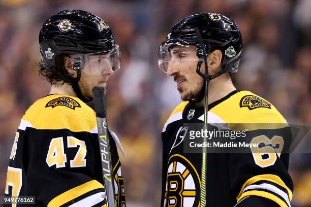 Torey Krug of the Boston Bruins talks with Brad Marchand during the first period of Game Five of the Eastern Conference First Round in the 2018...