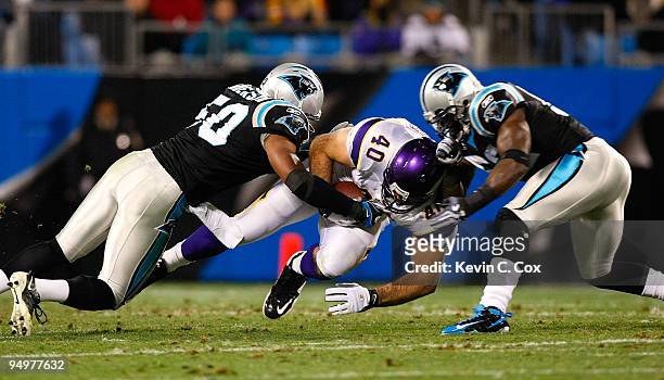 Jimmy Kleinsasser of the Minnesota Vikings dives for more yardarge against James Anderson and Jon Beason of the Carolina Panthers at Bank of America...