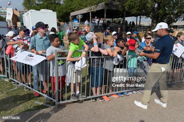 Ryan Moore signs autographs for young fans in the kids zone during the third round of the Valero Texas Open at TPC San Antonio - AT&T Oaks course on...