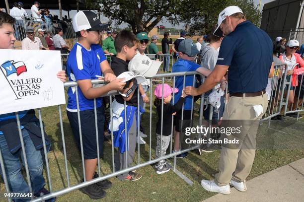 Ryan Moore gives a young fan his golf ball in the kids zone during the third round of the Valero Texas Open at TPC San Antonio - AT&T Oaks course on...