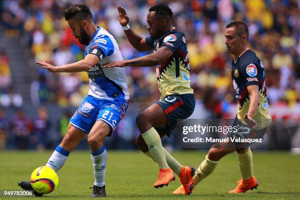 Jose Guerrero of Puebla struggles for the ball against Alex Ibarra Mina and Paul Aguilar of America during the 16th round match between Puebla and...