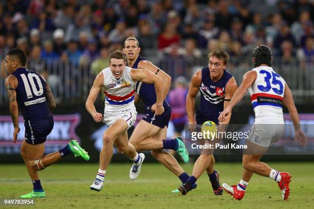 Mitchell Crowden looks to handball during the round five AFL match between the Fremantle Dockers and the Western Bulldogs at Optus Stadium on April...