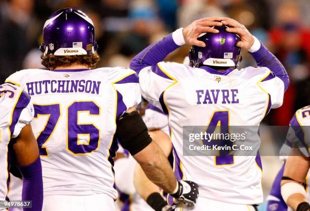 Quarterback Brett Favre of the Minnesota Vikings reacts after a turnover on downs to the Carolina Panthers as he walks off the field with Steve...