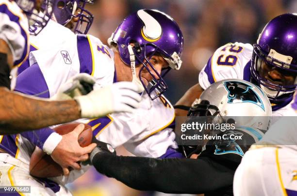 Quarterback Brett Favre of the Minnesota Vikings escapes a sack by Julius Peppers of the Carolina Panthers at Bank of America Stadium on December 20,...