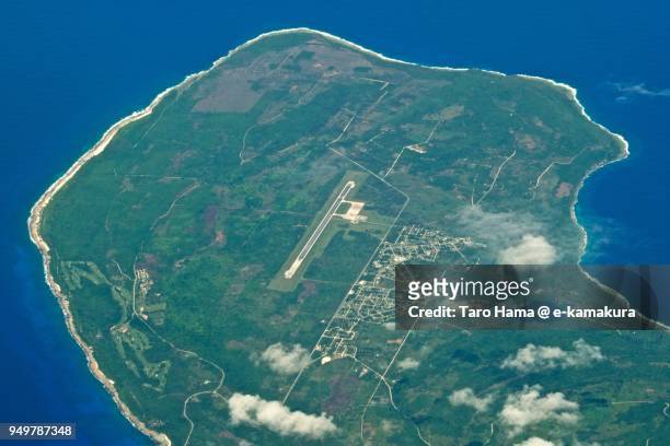 pacific ocean and rota island in northern mariana islands, daytime aerial view from airplane - northern mariana islands stock-fotos und bilder