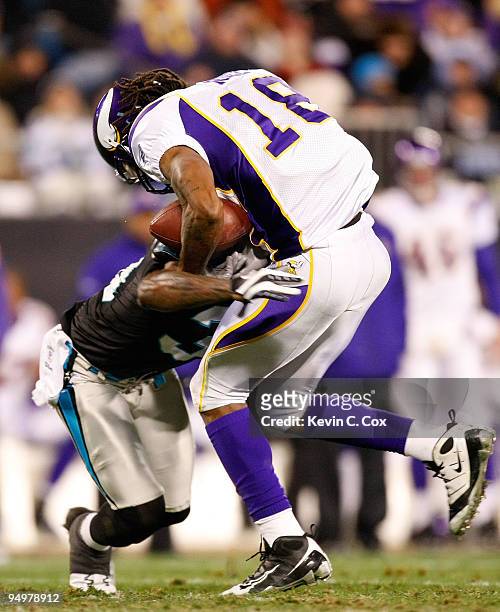 Charles Godfrey of the Carolina Panthers forces a fumble by Sidney Rice of the Minnesota Vikings at Bank of America Stadium on December 20, 2009 in...