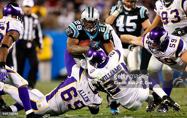 Jonathan Stewart of the Carolina Panthers rushes upfield against Jared Allen and Madieu Williams of the Minnesota Vikings at Bank of America Stadium...
