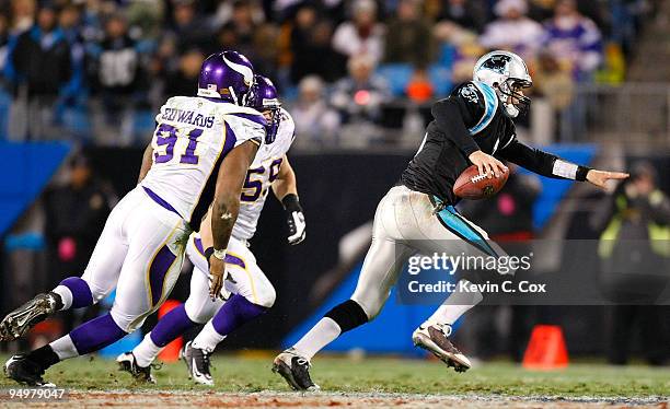 Quarterback Matt Moore of the Carolina Panthers escapes pressure by Ray Edwards and Jared Allen of the Minnesota Vikings at Bank of America Stadium...