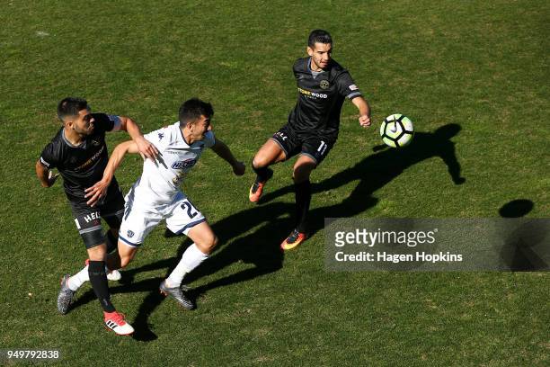 Emiliano Tade of Auckland City FC, Justin Gulley and Mario Barcia of Team Wellington compete for the ball during leg one of the OFC Champions League...