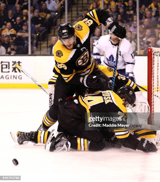 Kevan Miller of the Boston Bruins and Jake DeBrusk save a shot on goal during the second period against the Toronto Maple Leafs in Game Five of the...