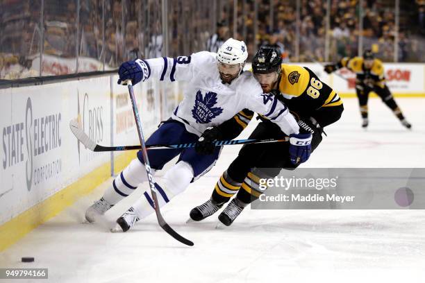 Nazem Kadri of the Toronto Maple Leafs and Kevan Miller of the Boston Bruins battle for control of the puck during the second period of Game Five of...