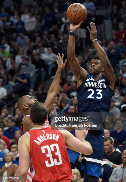 Jimmy Butler of the Minnesota Timberwolves shoots the ball against Chris Paul and Ryan Anderson of the Houston Rockets during the fourth quarter in...