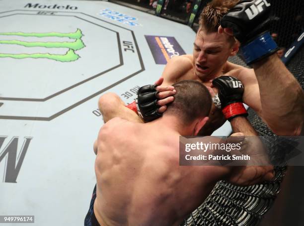 Jim Miller attempts to take down Dan Hooker of New Zealand in their lightweight fight during the UFC Fight Night event at the Boardwalk Hall on April...