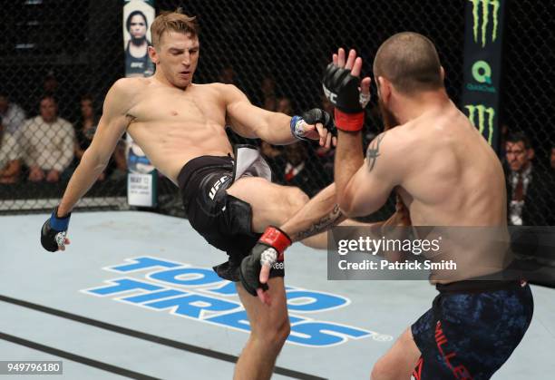 Dan Hooker of New Zealand kicks Jim Miller in their lightweight fight during the UFC Fight Night event at the Boardwalk Hall on April 21, 2018 in...