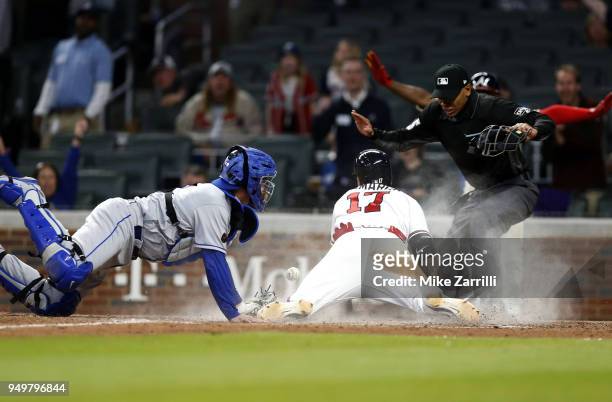 Third baseman Johan Camargo of the Atlanta Braves slides into home plate for the game winning run behind the tag of catcher Jose Lobaton of the New...