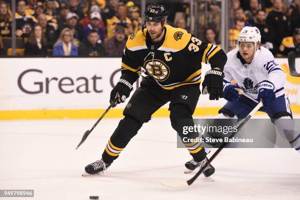 Zdeno Chara of the Boston Bruins skates after the puck against Connor Brown of the Toronto Maple Leafs in Game Five of the Eastern Conference First...