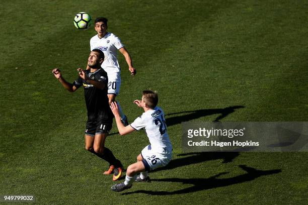 Mario Barcia of Team Wellington controls the ball under pressure from Callum McCowatt and Emiliano Tade of Auckland City FC during leg one of the OFC...
