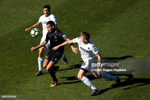 Mario Barcia of Team Wellington controls the ball under pressure from Callum McCowatt and Emiliano Tade of Auckland City FC during leg one of the OFC...
