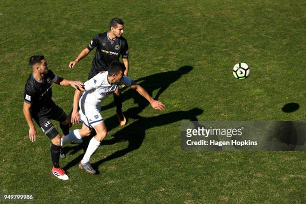 Emiliano Tade of Auckland City FC controls the ball under pressure from Mario Barcia and Justin Gulley of Team Wellington during leg one of the OFC...
