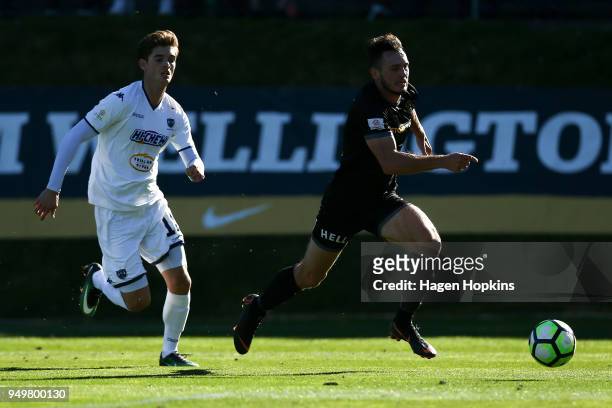 Eric Molloy of Team Wellington makes a break from Alfie Rogers of Auckland City FC during leg one of the OFC Champions League 2018 Semi-finals series...