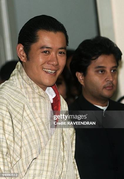 King of Bhutan Jigme Khesar Namgyel Wangchuck walks with Indian Minister of State for Commerce and Industry Jyotiraditya Scindia as he arrives at...