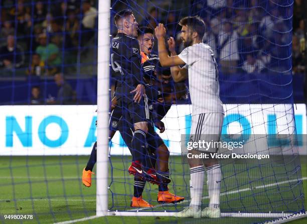 Defender Jorgen Skjelvik of Los Angeles Galaxy looks on as Miguel Almiron of Atlanta United jumps on teammate Josef Martinez after Martinez scored...