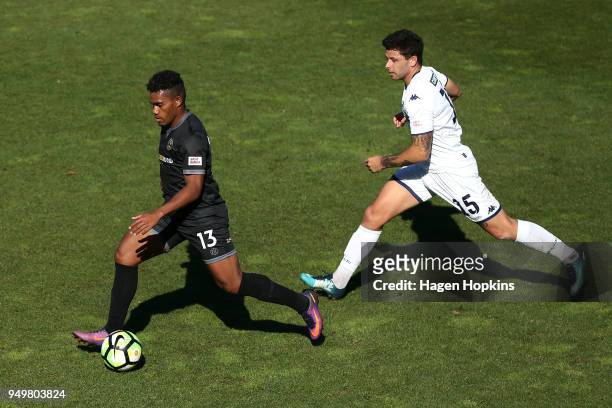 Roy Kayara of Team Wellington makes a break from Dan Morgan of Auckland City FC during leg one of the OFC Champions League 2018 Semi-finals series...